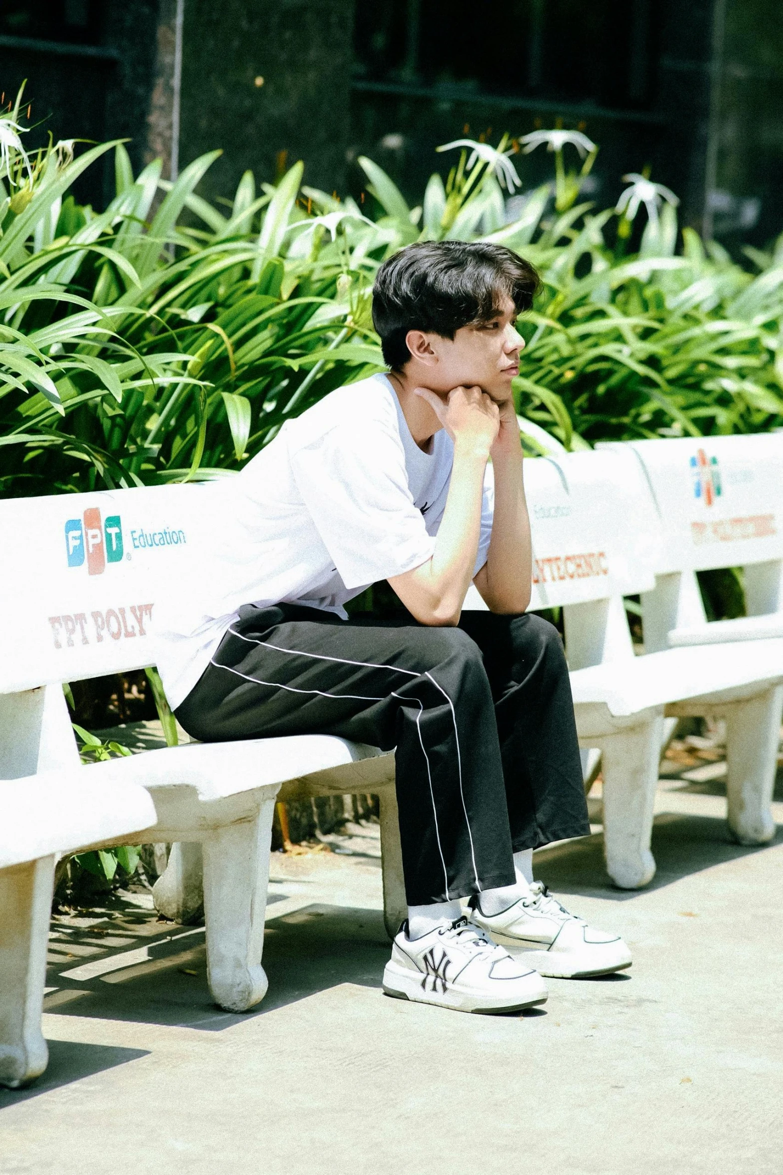 a man is sitting on a bench and staring