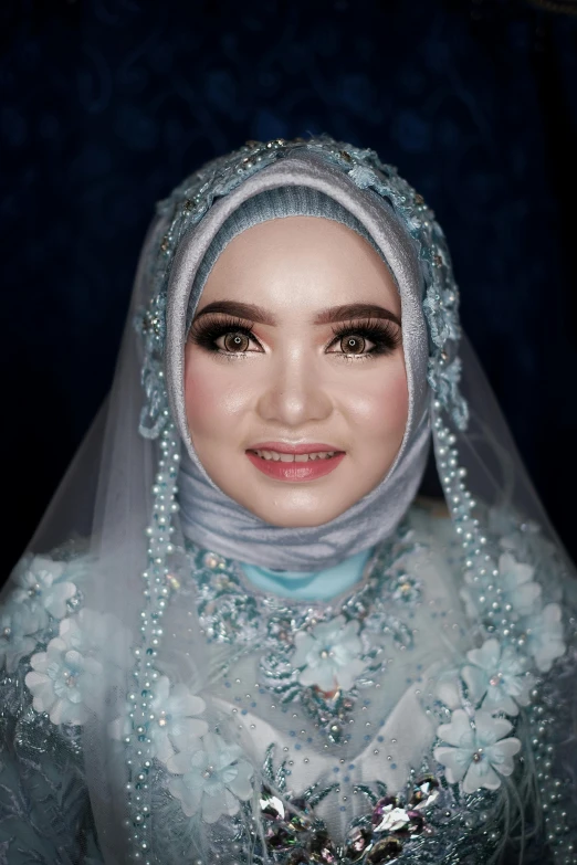the bride wearing an oriental outfit is smiling