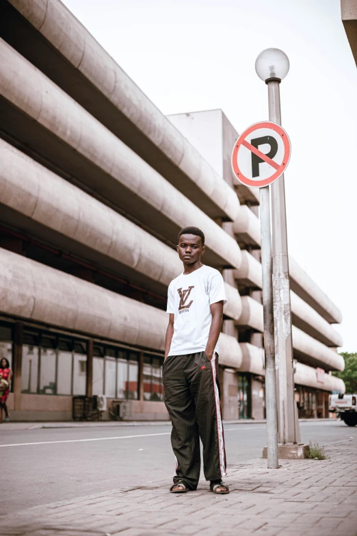 a man is standing near a sign and a no parking sign