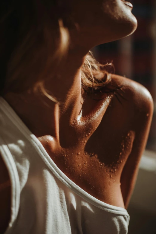 a woman with very small white spots on her neck