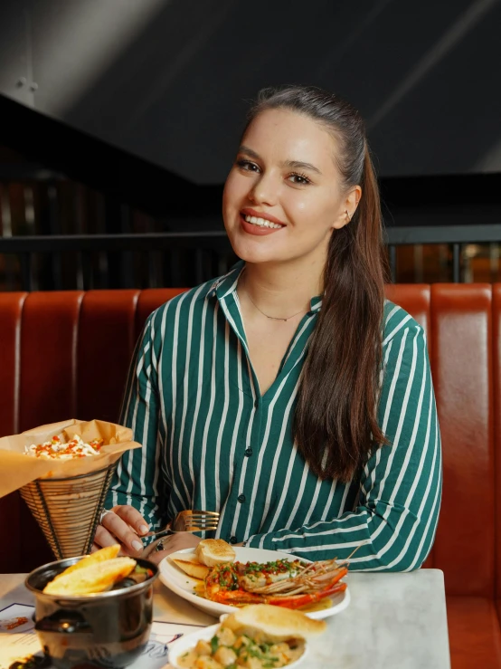 a woman in a striped shirt is having food