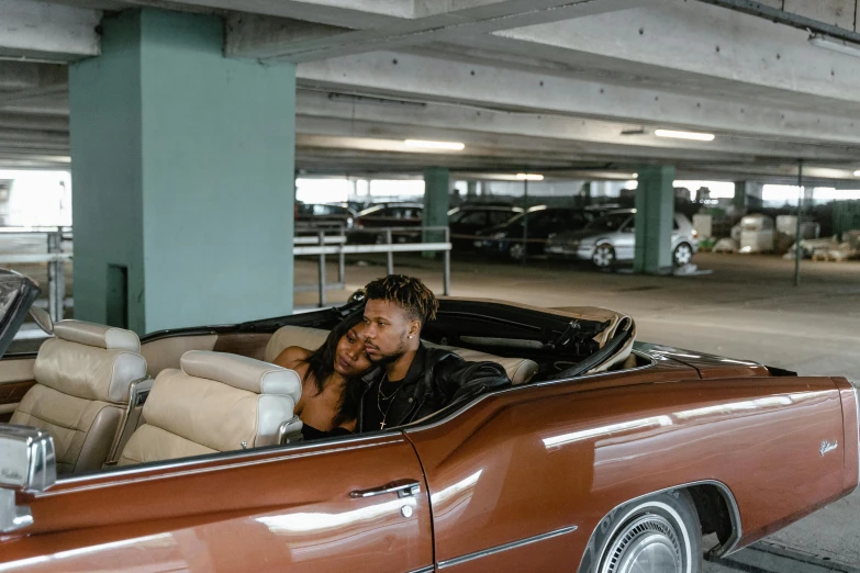 a man sitting inside of a car filled with furniture