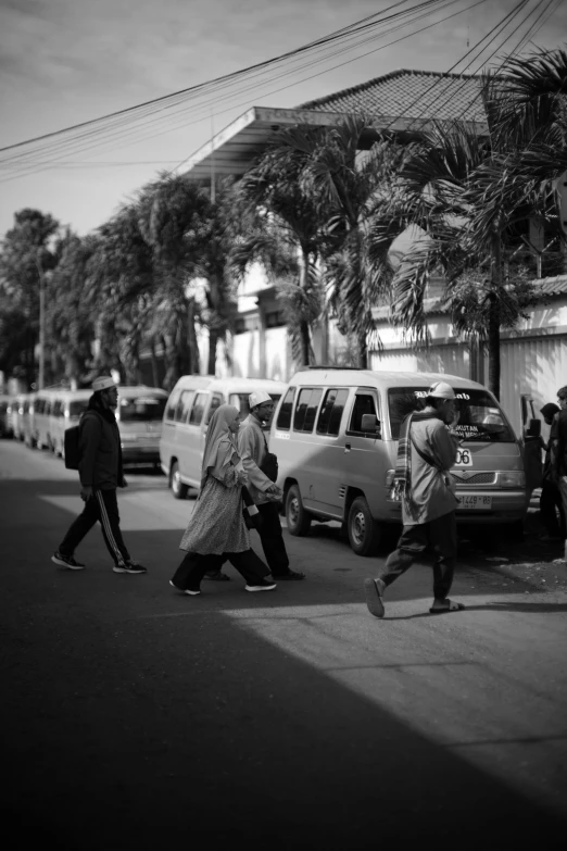 pedestrians walking on the street near cars and people