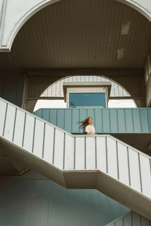 a person sitting on a staircase with their arms in the air