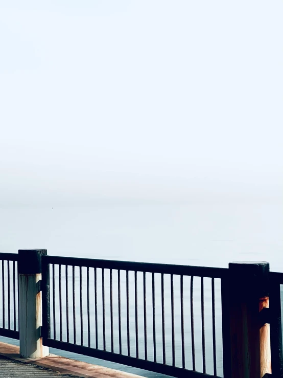 a man and a woman on their cell phones looking out at the ocean