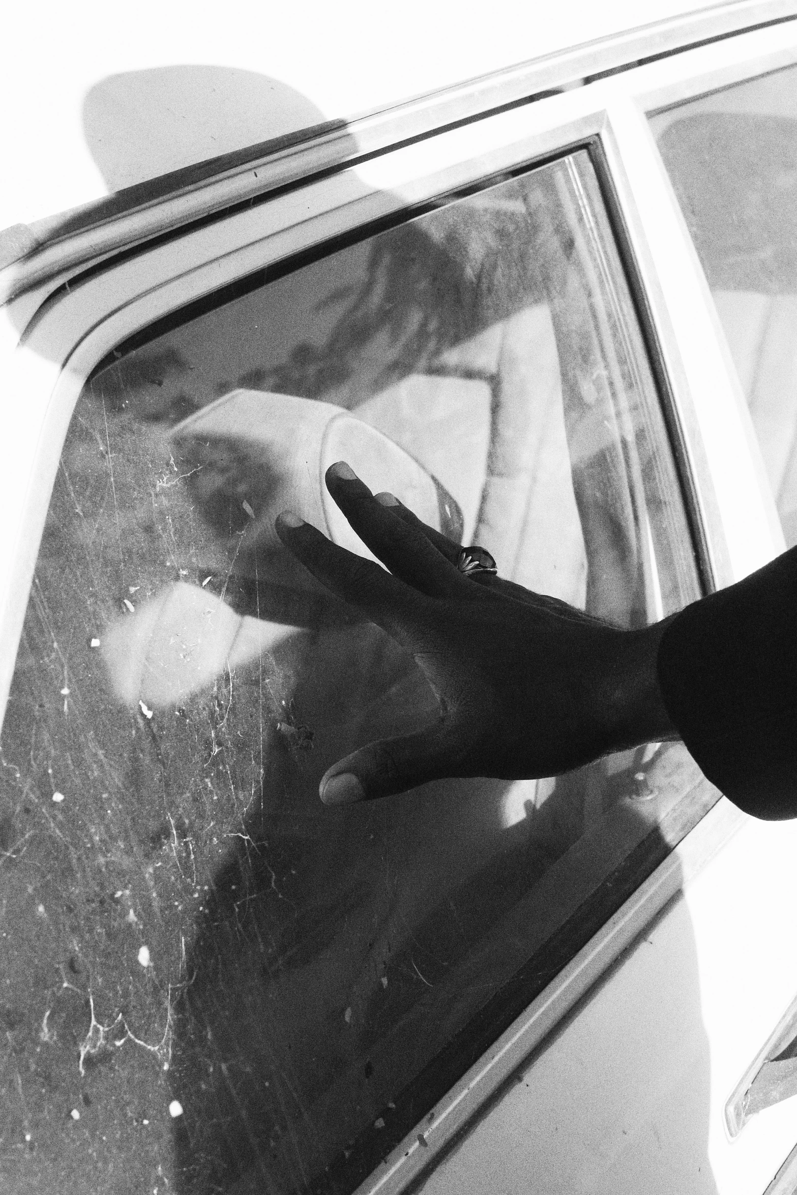 a man is getting out of his car with his hand on the window