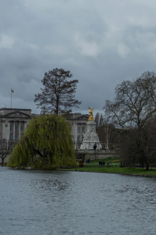 a large building sitting across from a lake in front of it