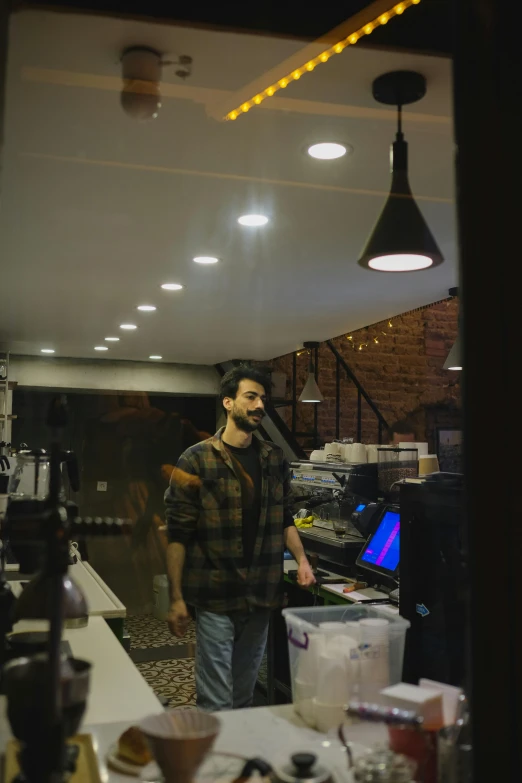 a man is standing in the kitchen looking at the counter