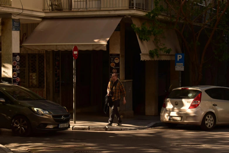 a person with their foot in the air walking on a sidewalk