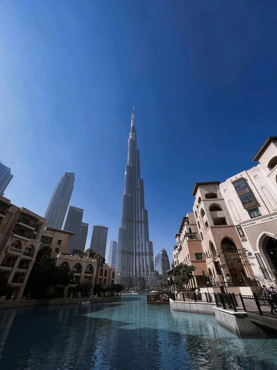 the burj tower towering over some city buildings