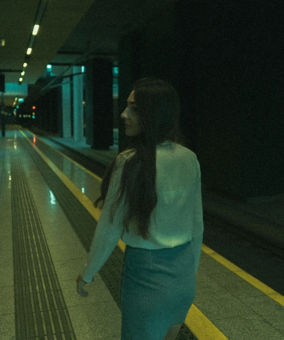 a woman standing next to a train at the platform