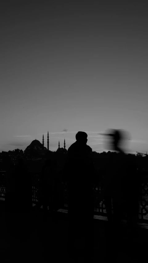 silhouette pograph of building against sky and a person wearing hat