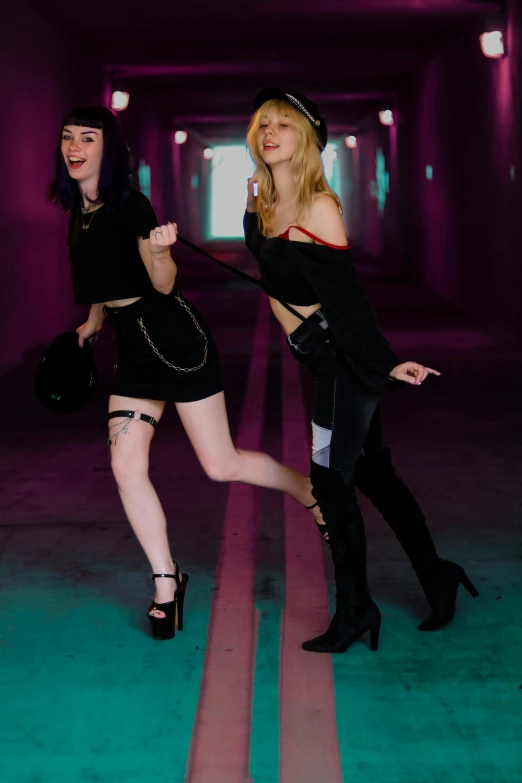 two women dressed in goth outfits and high heels