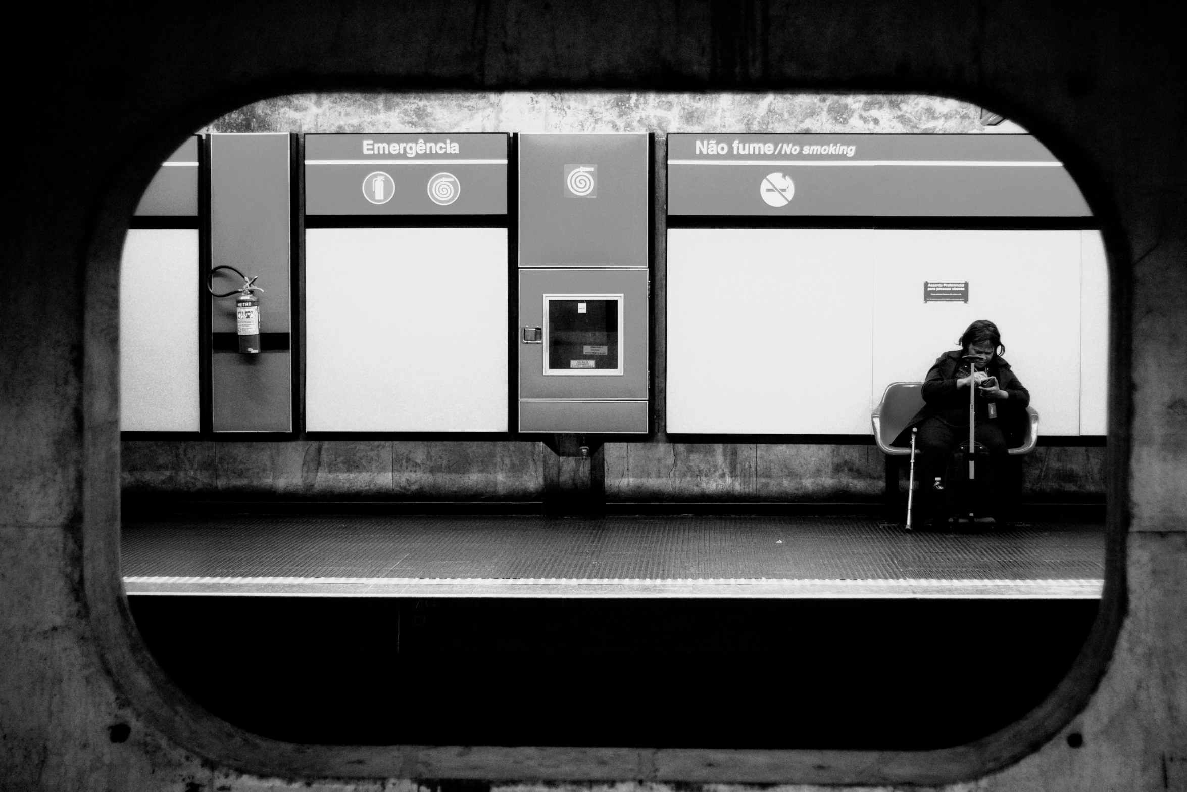 the person is sitting outside on the train