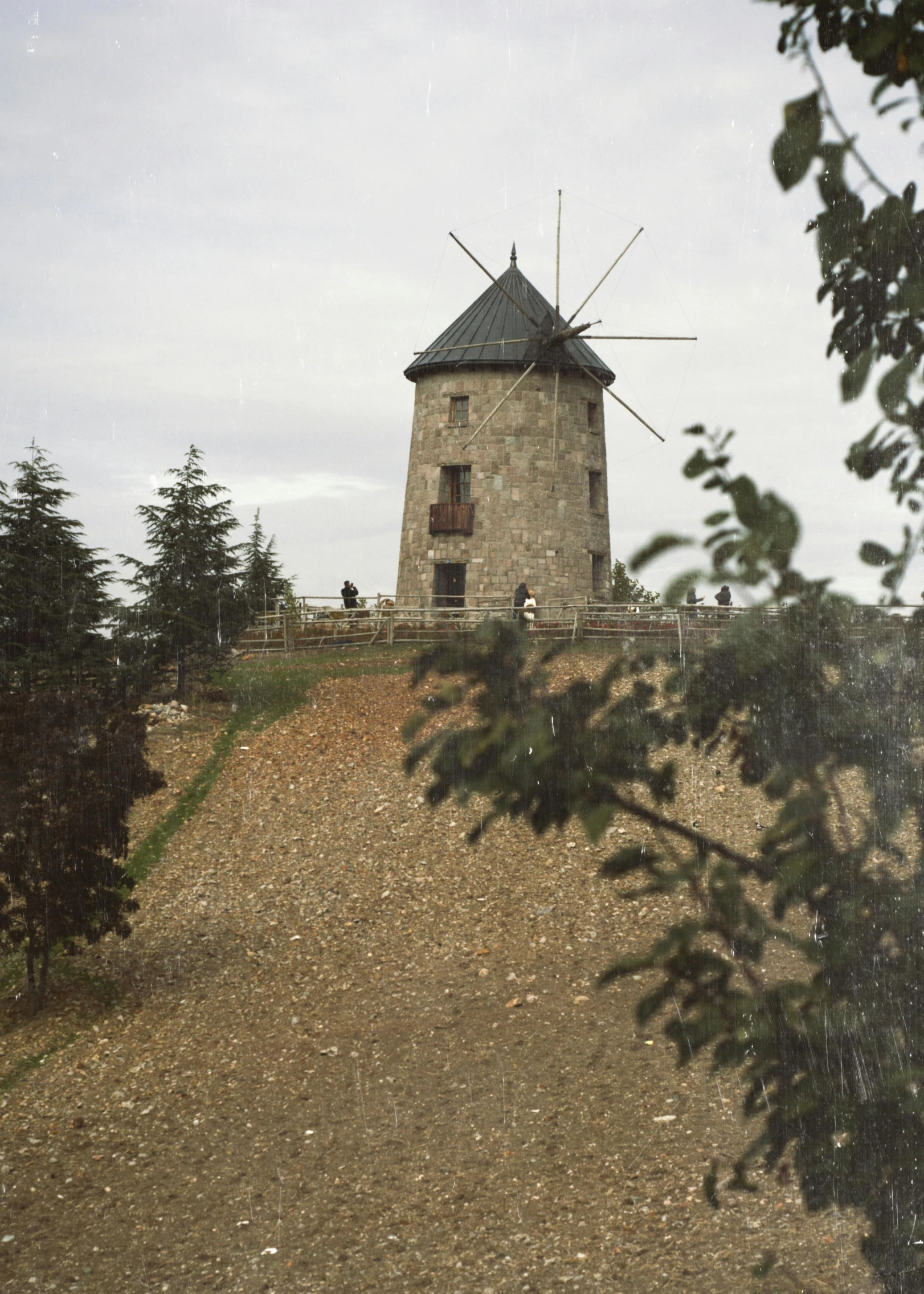 a tower on a hill that appears to be overcast