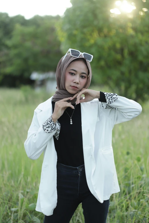 woman wearing black jeans and a white jacket with an animal print on it