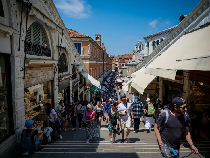 a group of people walking down a narrow street