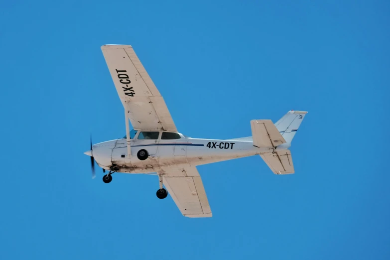 an old propeller plane flying high up in the air