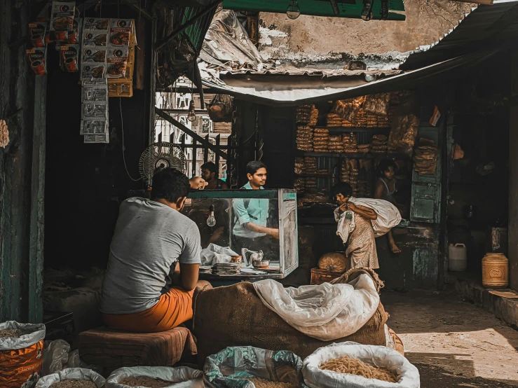 two people sit next to each other in front of stores