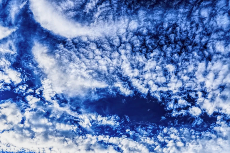 a blue sky with a plane flying by