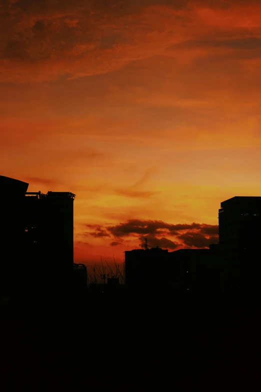 the cityscape is visible through the orange sky