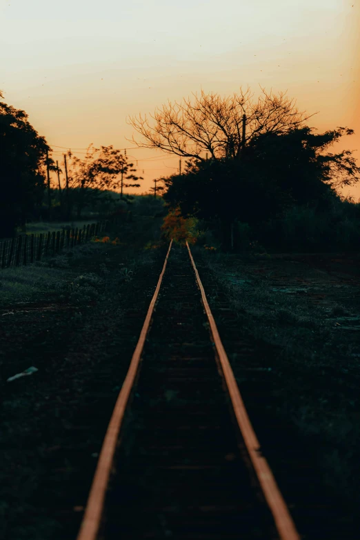 a view of some tracks with the sun setting