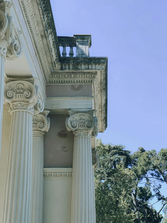 a clock on top of a white column outside