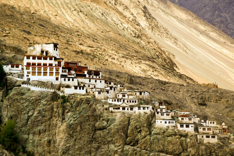 the houses are perched on the rock, on the mountain