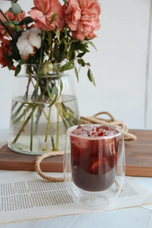 the pitcher and glass are holding strawberries on the table