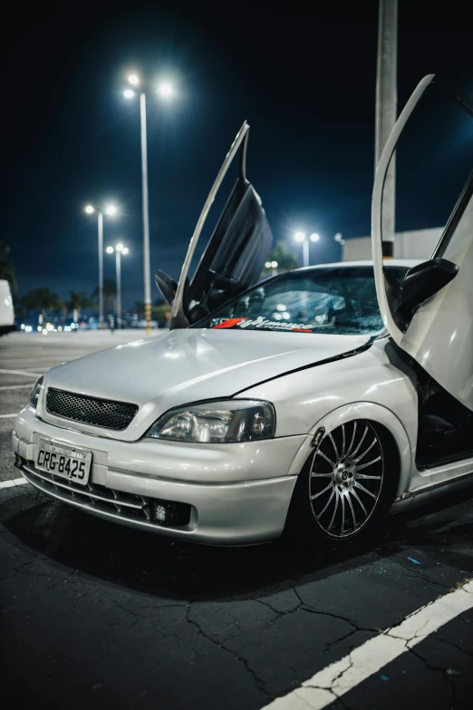 a car with the open door showing it's hood