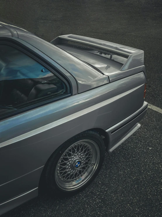 an old car is parked in a parking space