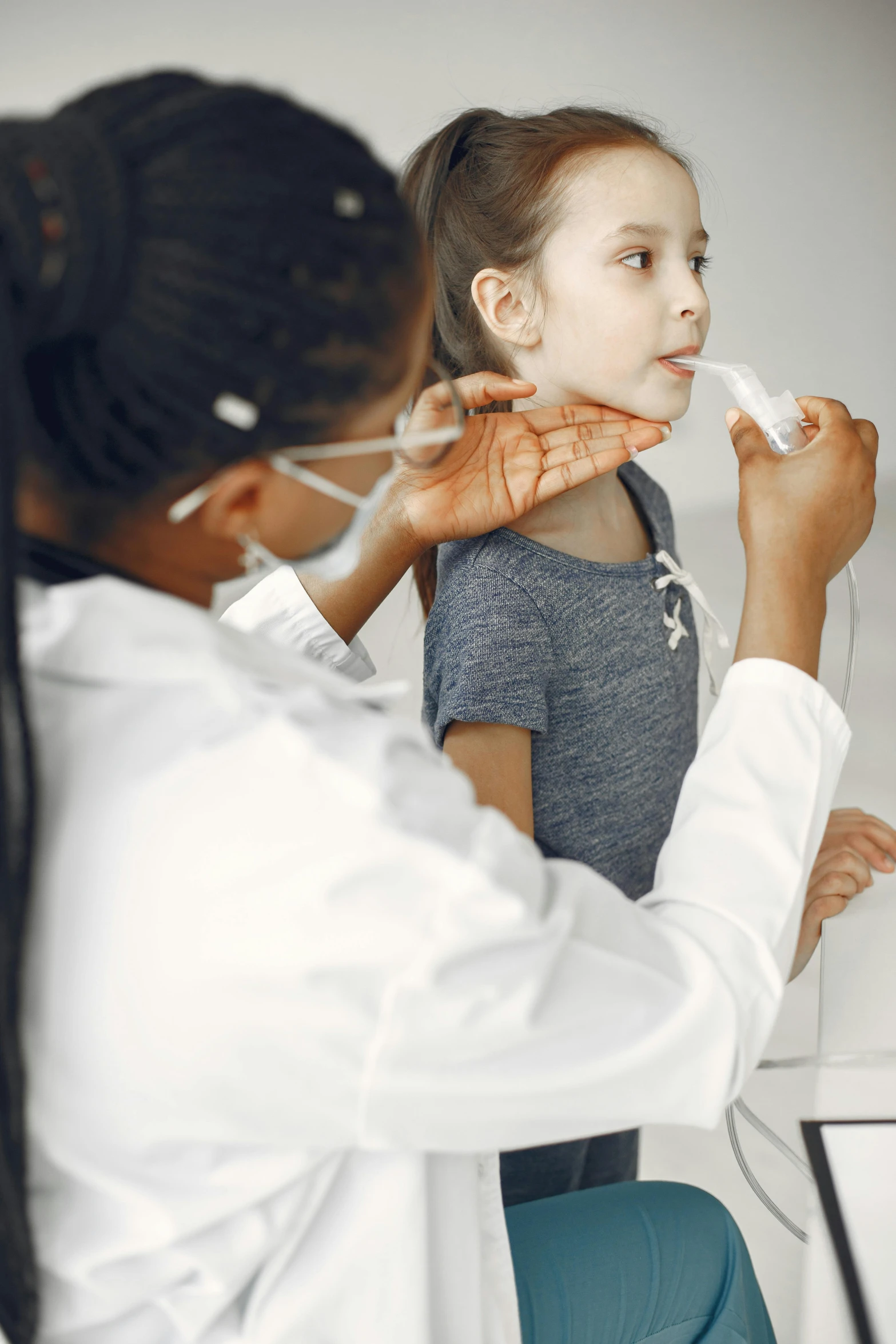 a girl is in the doctor's office while doing her teeth