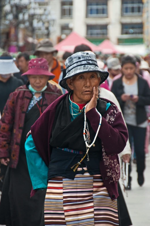 some old women walking and talking on cell phones