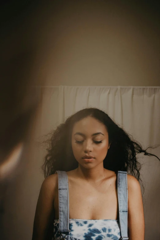 a woman is posing for the camera in overalls