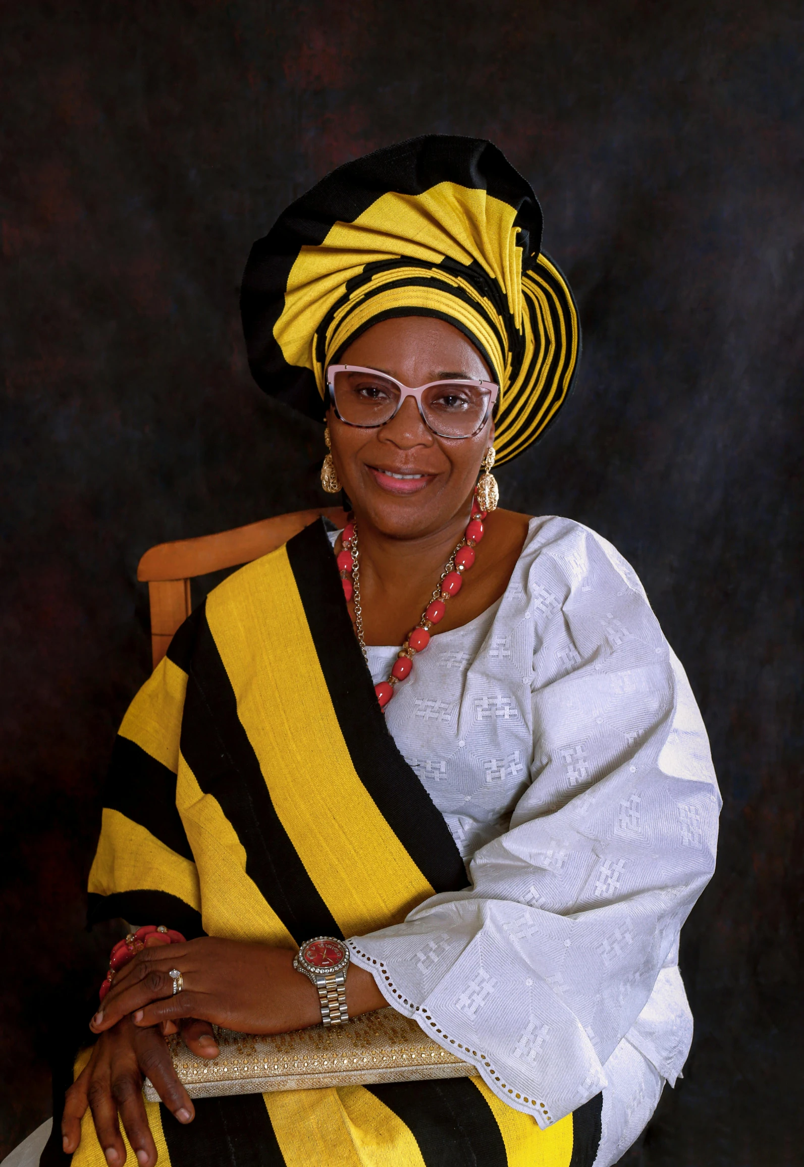 a woman wearing glasses is sitting in a chair