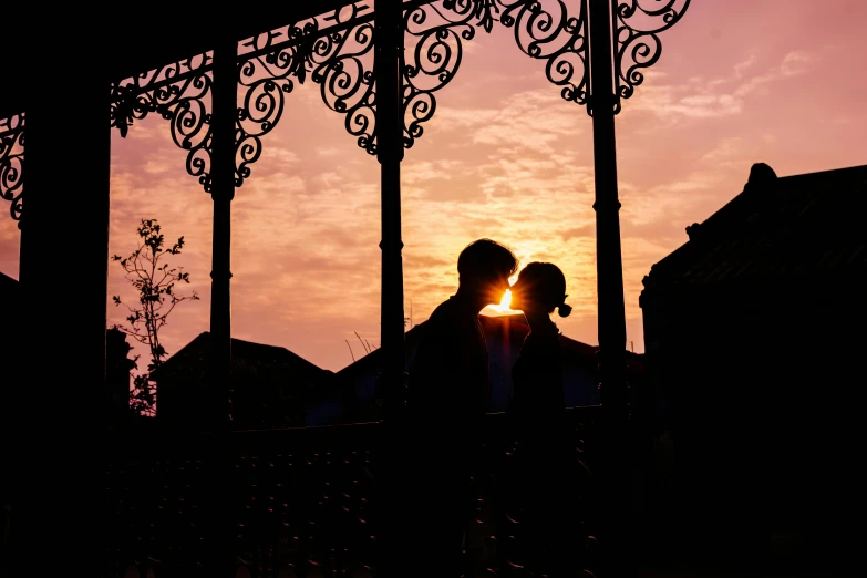 a man and woman kissing under an umbrella