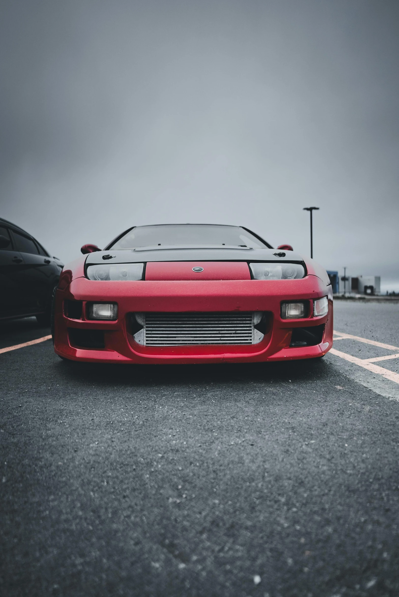 a red sports car is parked in the lot