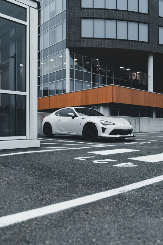 white sports car parked in front of building