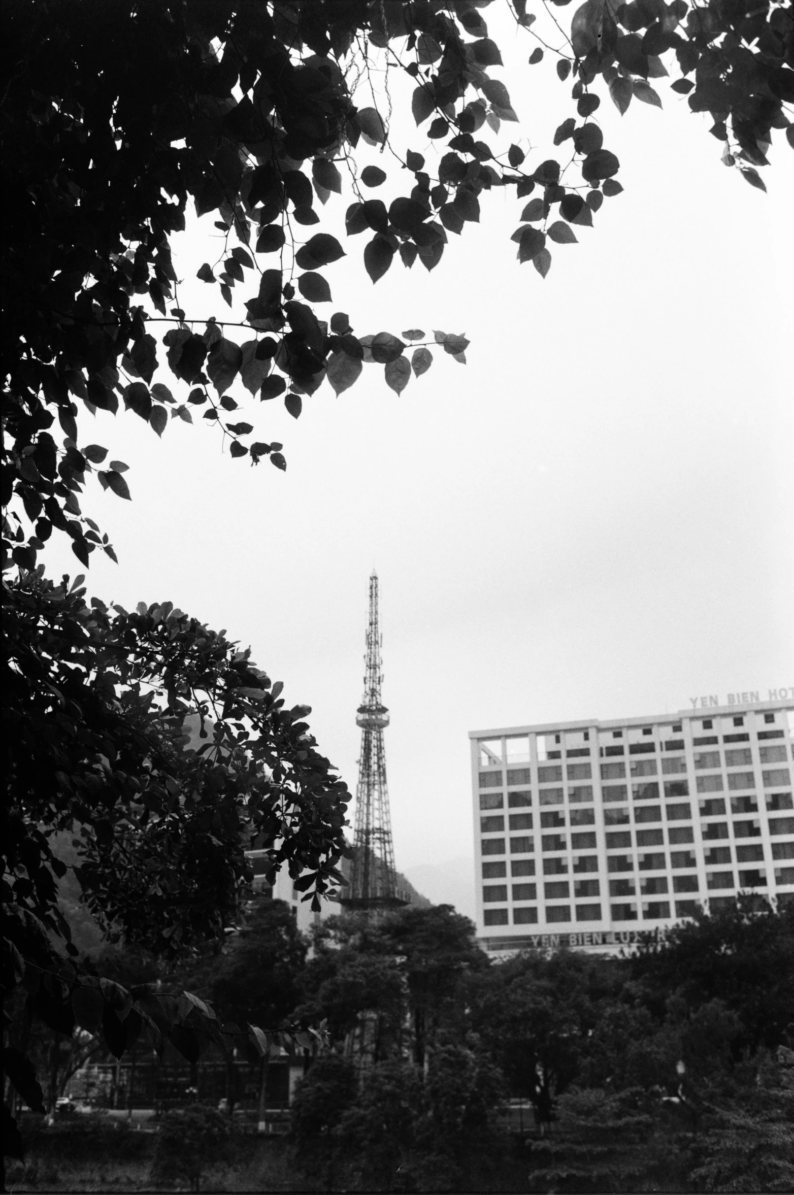 a black and white po of people on a bridge and buildings in the background