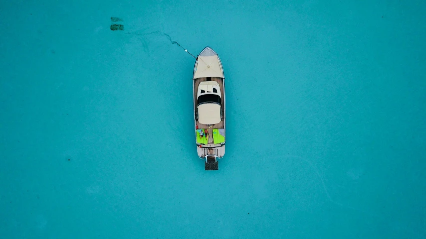 an overhead view of a boat in the middle of the ocean