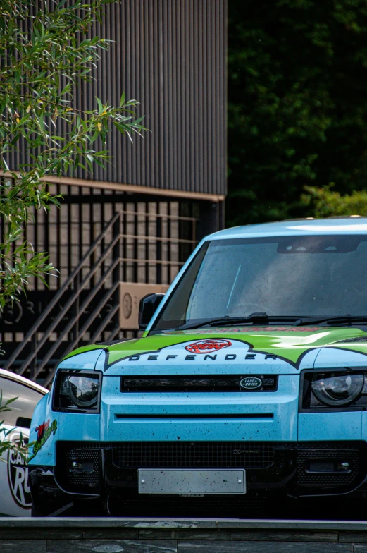 a vehicle with decorative paint sitting in front of a building