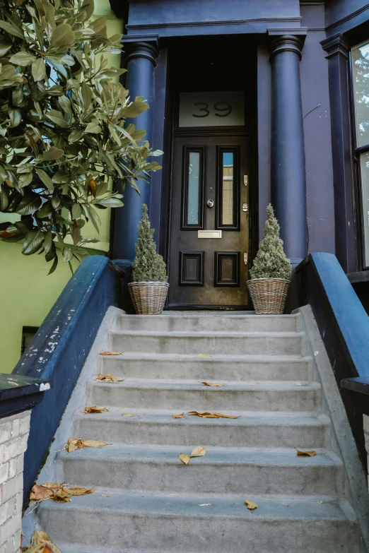 an entrance leading to a green house with trees