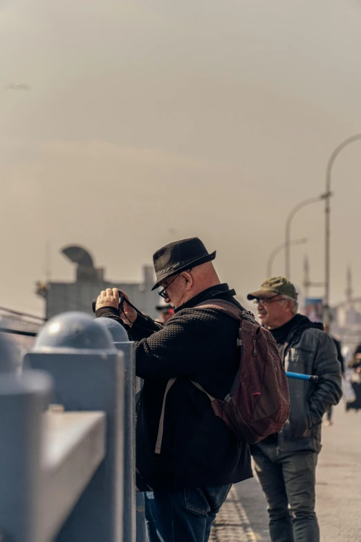 an older man holding his drink in his left hand