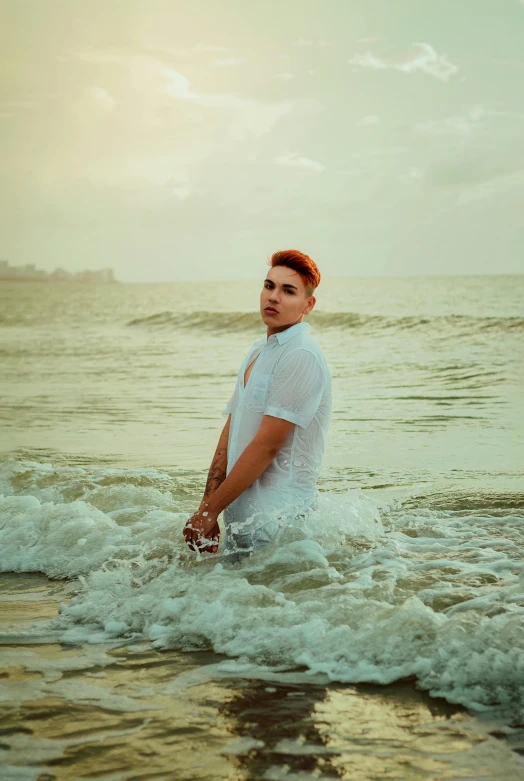 a man stands in the water of the beach