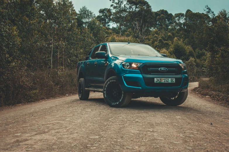 a pick up truck is on a dirt road