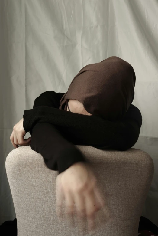 a man in a mask rests on a chair