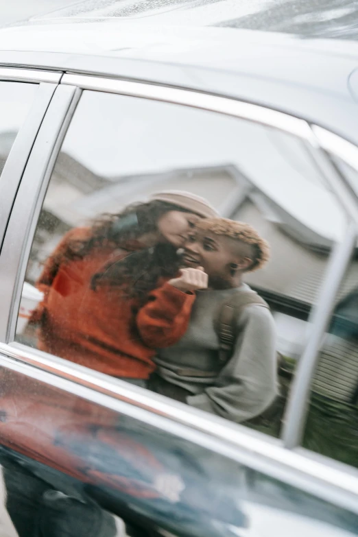 the reflection of a man and woman in a car