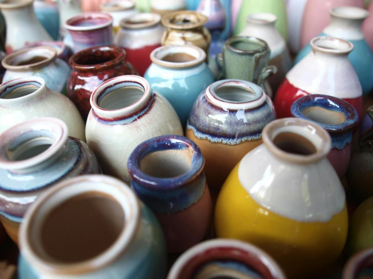 many different vases are laying in a pile