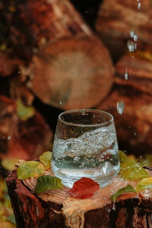 a glass filled with water and next to another glass with some liquid on it