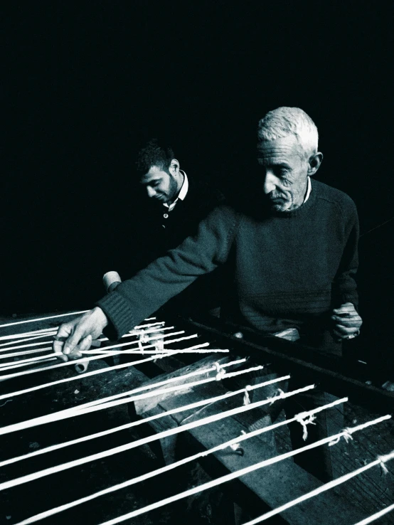 two men are playing keyboard on a stage